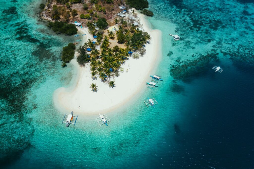 Aerial shot of Pass Island with white sand beach and turquoise water