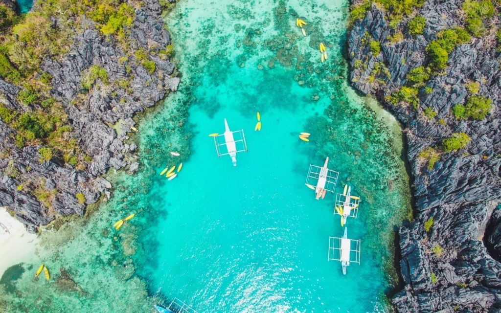Aerial-view-of-El-Nido-with-blue-lagoon-and-towering-limestone-cliffs-one-of-the-best-places-to-stay-in-Palawan