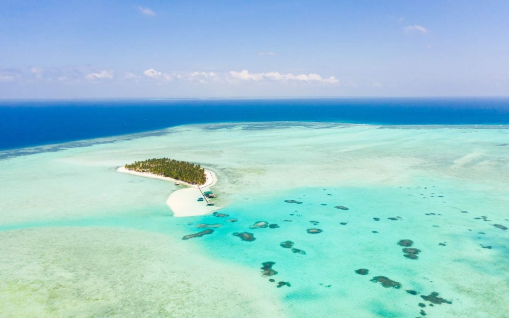 
Aerial view of Onok Island, one of the best places to stay in Balabac Palawan, with clear blue waters and white sand