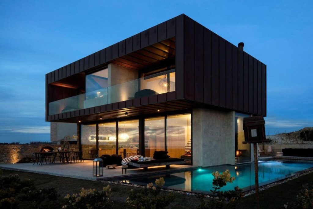 luxury 2-storey villa with glass windows from outside at night