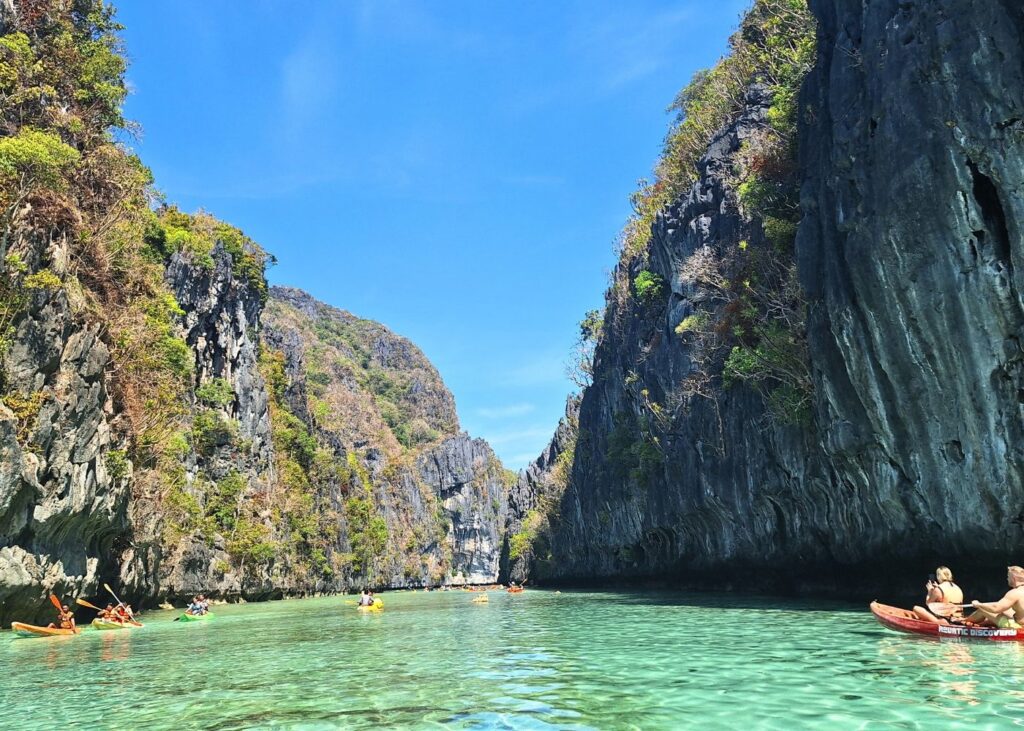 tourists kayaking on the Big Lagoon in El Nido Palawan