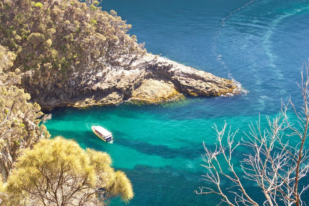 top view of a boat in the turquoise waters of Bruny Island