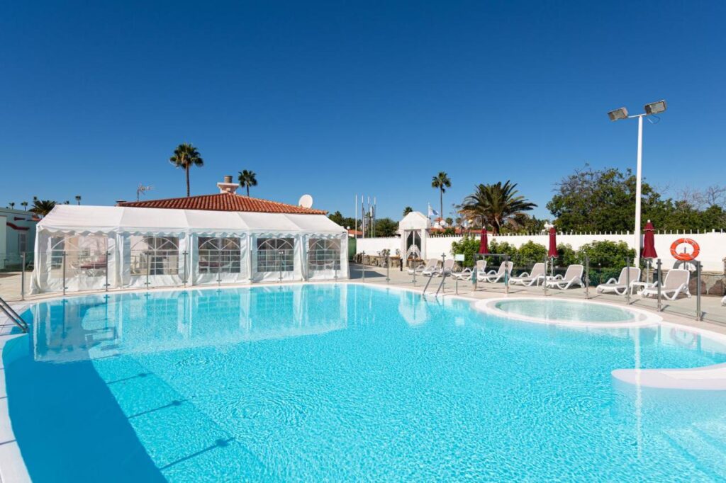 outdoor pool with crystal blue waters at Bungalows Tisaya Golf