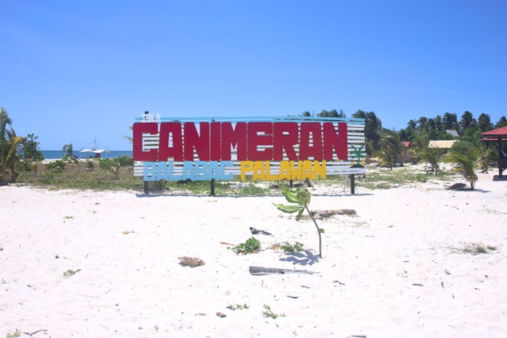 Canimeran sign on island in Balabac Palawan with brush and white sand