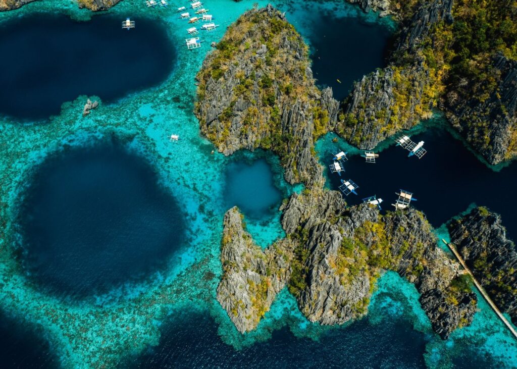 Aerial view of blue waters and lagoons on Coron with boats