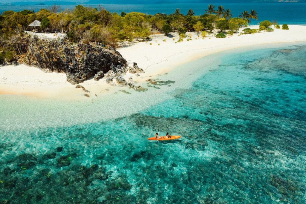 Couple kayaking in Coron Palawan near a sandbar