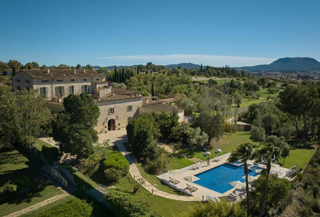top view of the hotel estate with lush green trees and outdoor pool