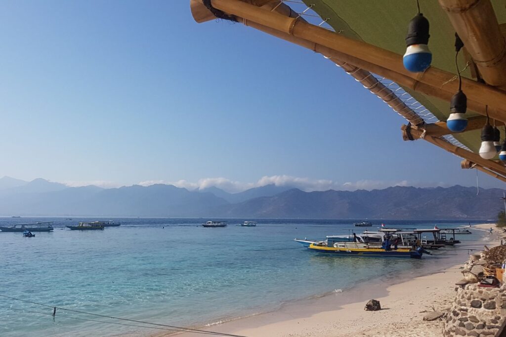 boats docked at the shore of an Gili island