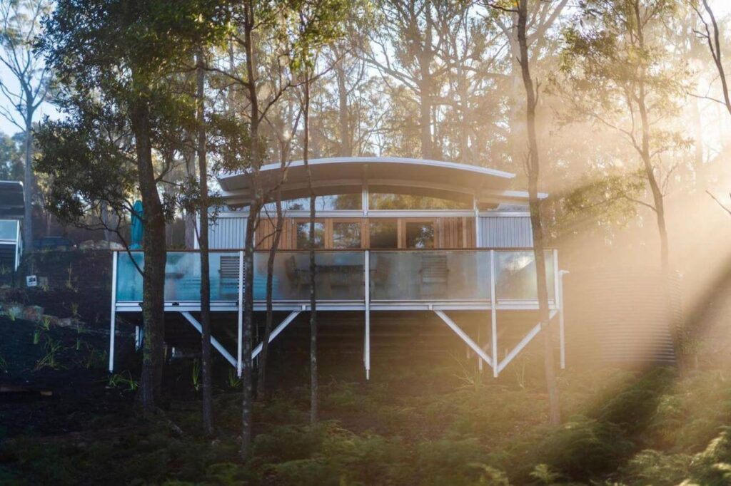 Free Spirit Pods exterior situated in a forest area with trees
