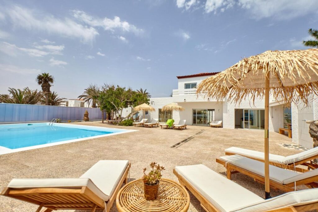 outdoor pool with tropical vibes at Hélène Holidays