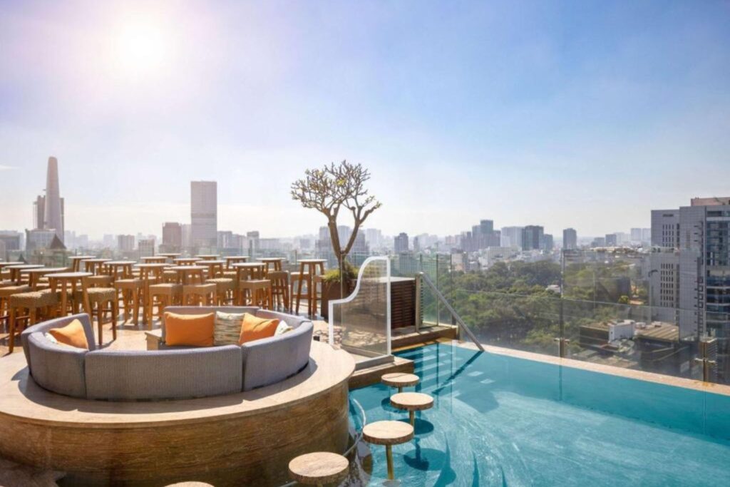 Hotel Des Arts Saigon Mgallery Collection rooftop pool and bar with Ho Chi Minh Skyline