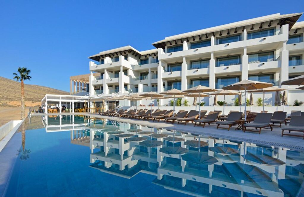 front hotel facade with an outdoor pool