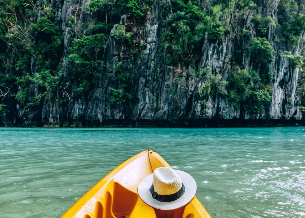 Kayak and hat in green waters or El Nido