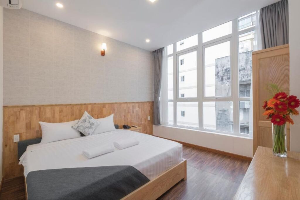 King bed in a bright room at Beauty House