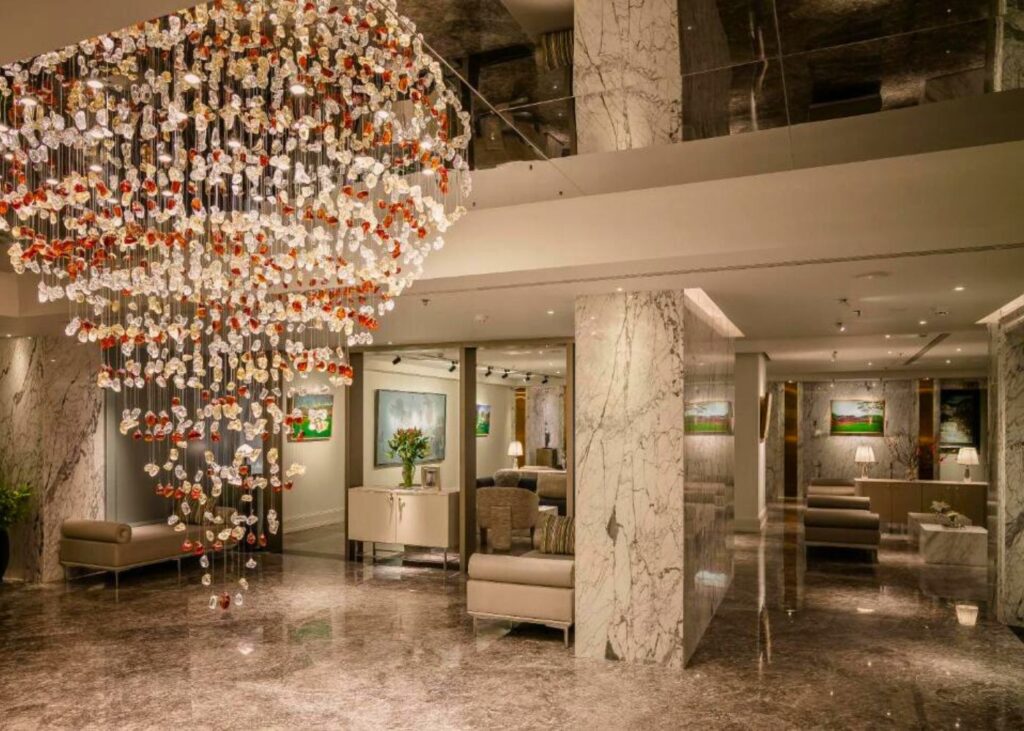 Large chandelier and marble lobby at Le Jardin Hotel Haute Couture