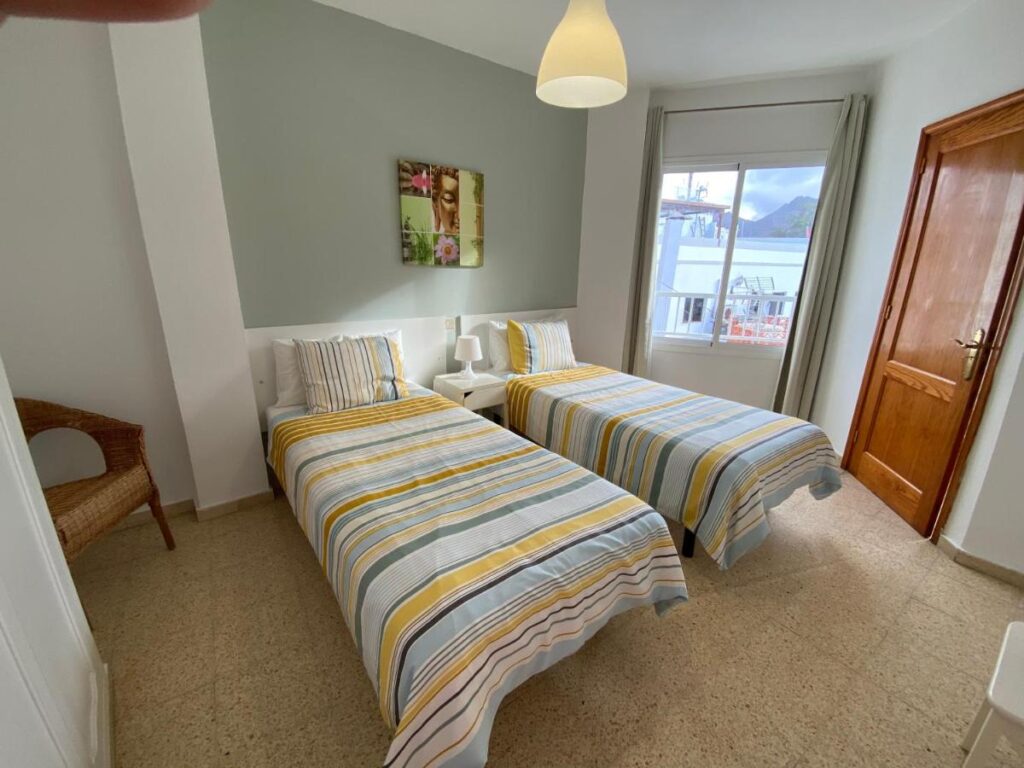 two single beds in a one bedroom apartment