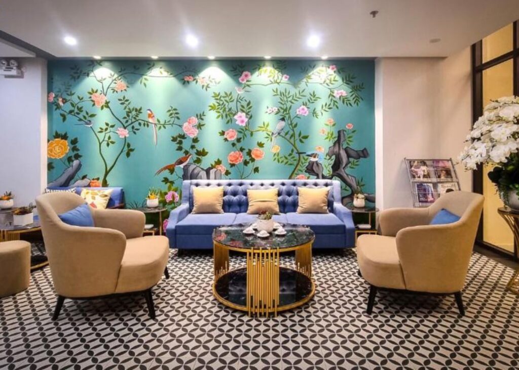 lobby in VNAHOMES APARTHOTEL with floral wallpaper and blue sofa