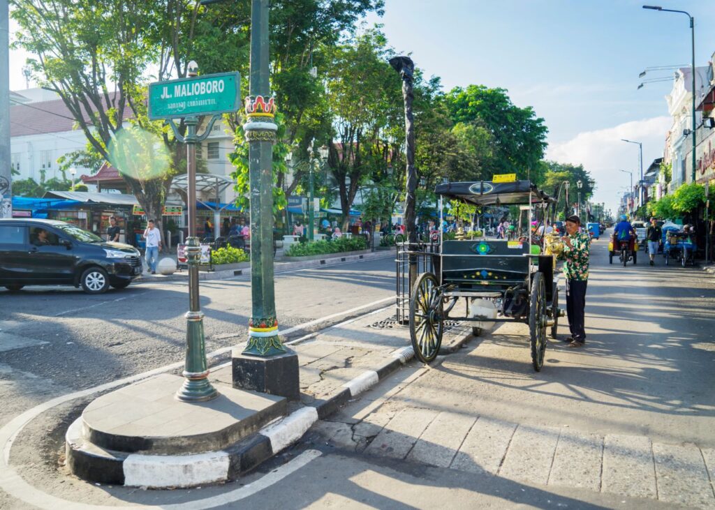 car and a traditional transportation in Malioboro Street