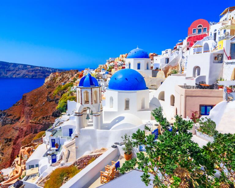 Scenic view of Oia, Santorini Island, Greece, Europe. White buildings against blue sea and sky.
