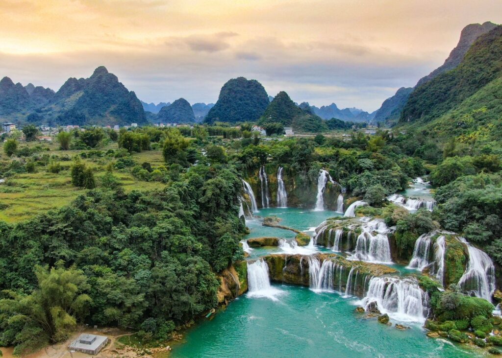 Multiple cascades of Ban Gioc Waterfall in Cao Bang Province Vietnam with lush greenery and mountains