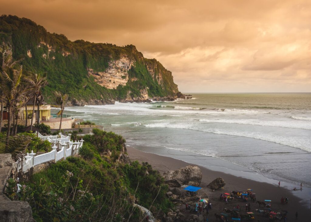 panoramic view of Parangtris Beach with beautiful sky and mountains