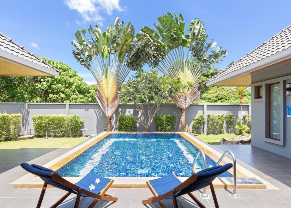 Private pool at Lady Naya Villas with lounge chairs and east-west palms