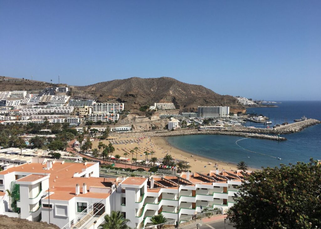 panoramic view of the beach, buildings and mountains in Puerto Rico Beach, Gran Canaria