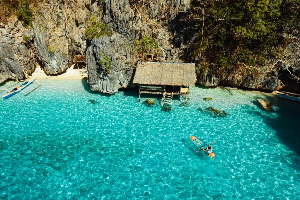 Remote hut in Coron Palawan with kayaker