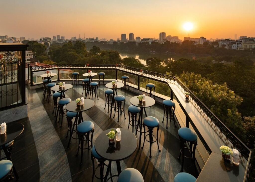 rooftop dining area at La Sinfonia del Rey Hanoi during sunset