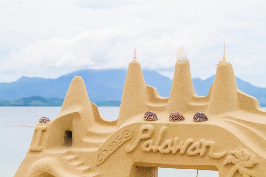 Sandcastle with mountains in backround on Honda Bay