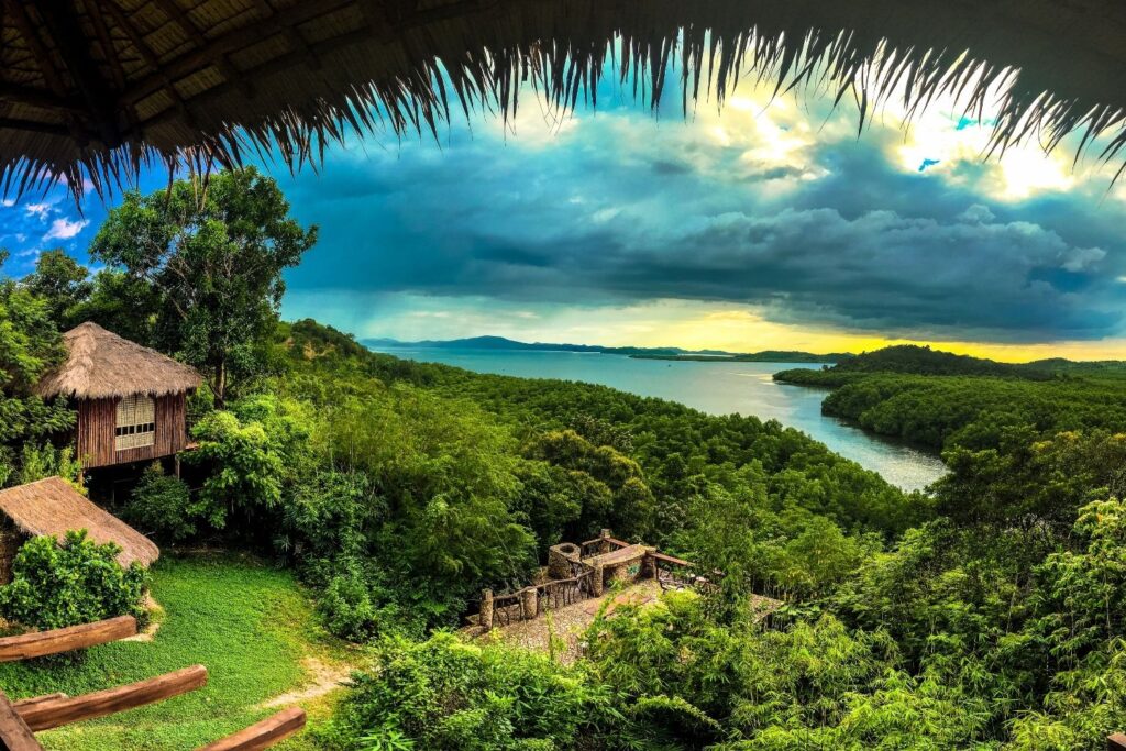Thatched roof hut overlooking jungle and lake in Coron Palawan
