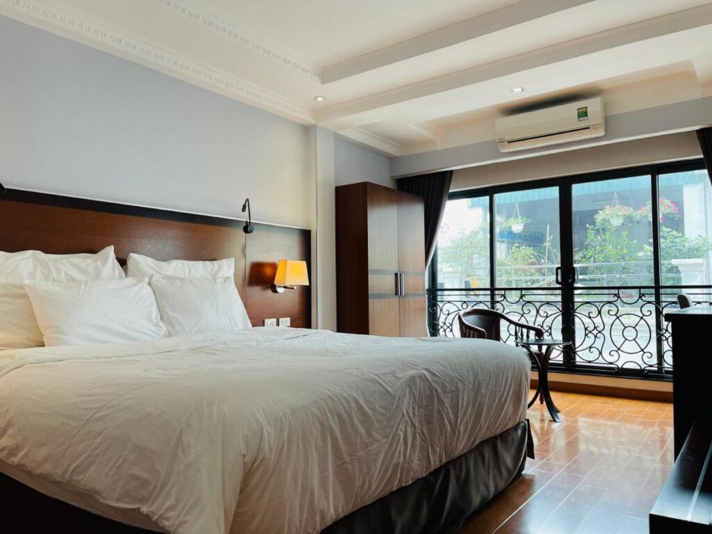 bedroom with wide glass windows and a large bed