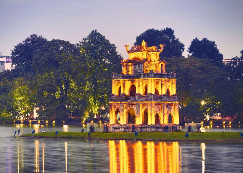Turtle Tower and Hoan Kiem Lake in Hanoi at night with lights on the water