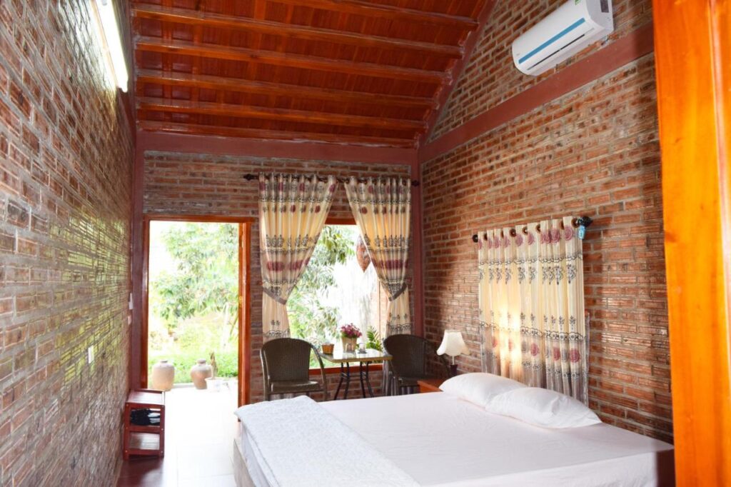 small bedroom with tiled walls and an aircondition
