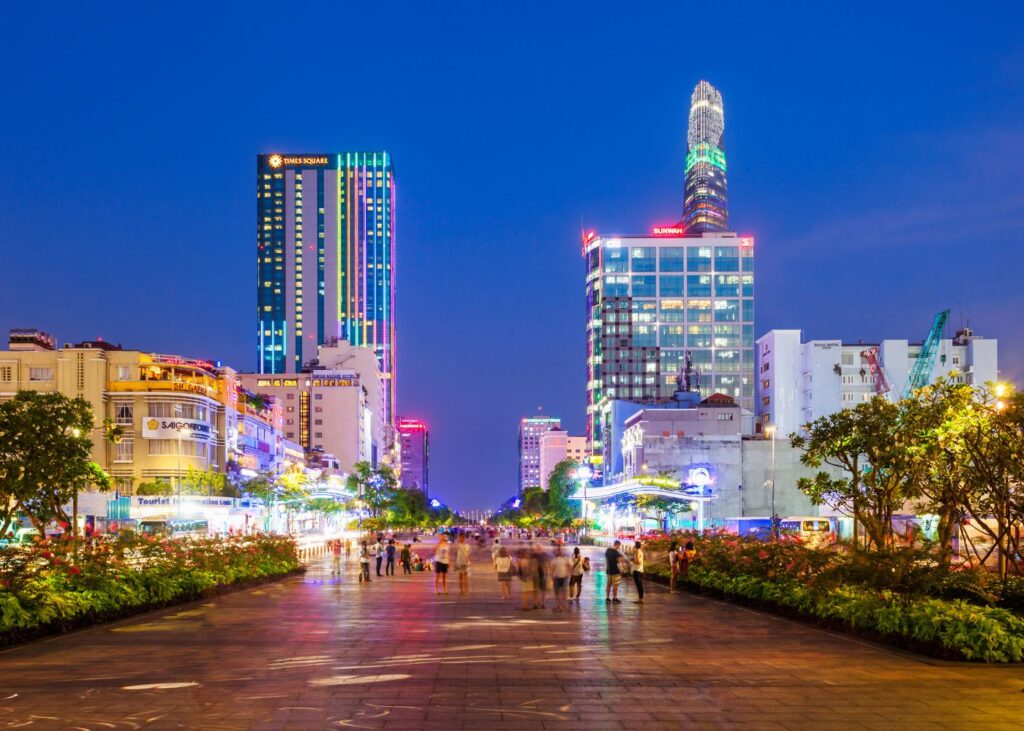 Walking street in Ho Chi Minh city at night with lighted skyline