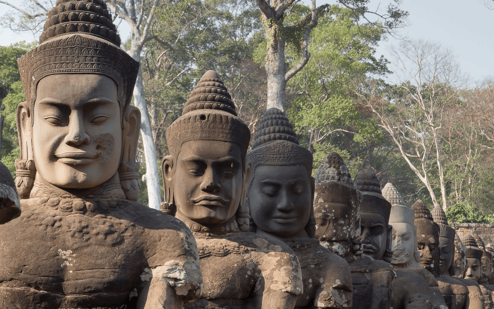 Row of carved heads in Angkor near Siem Reap