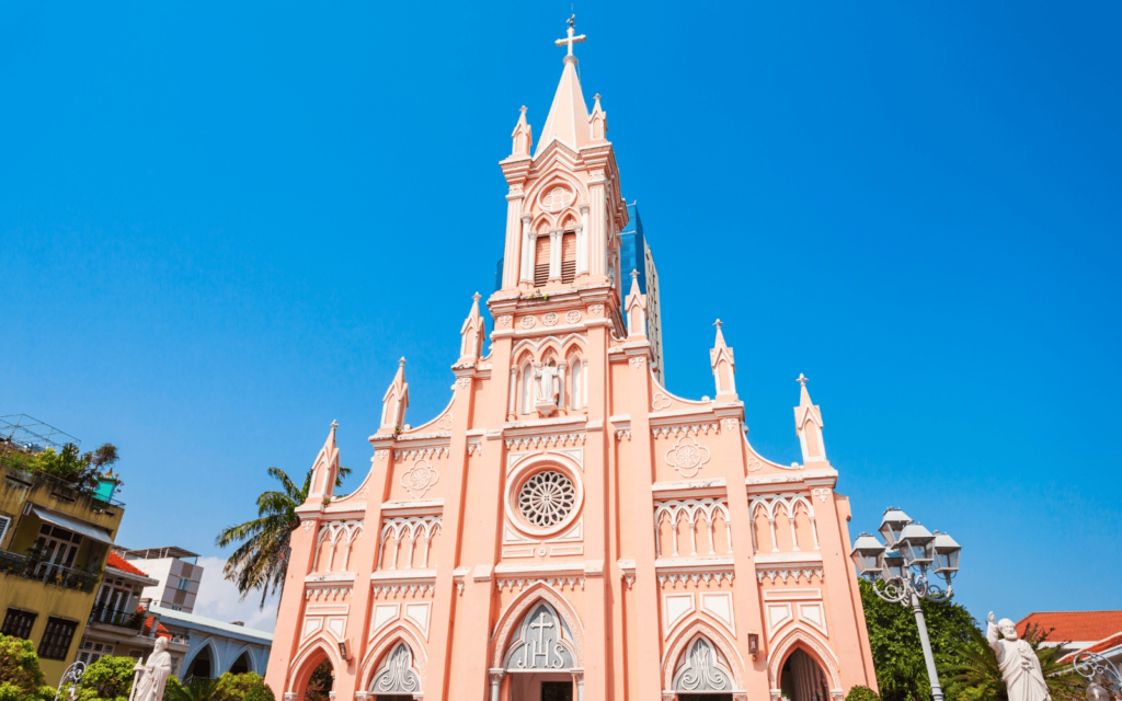 Pretty pink Da Nang Cathedral against a blue sky is a must vist stop on any Da Nang itinerary