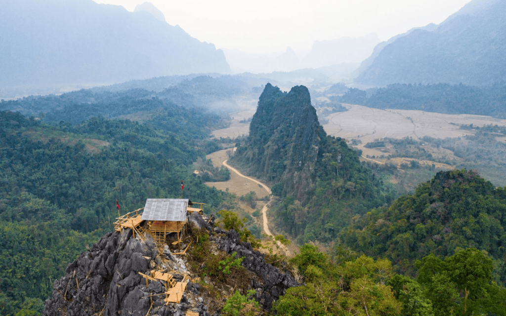 Aerial view over Nam Xay Viewpoint in Laos with river and limestone karsts and a wooden hiking trail