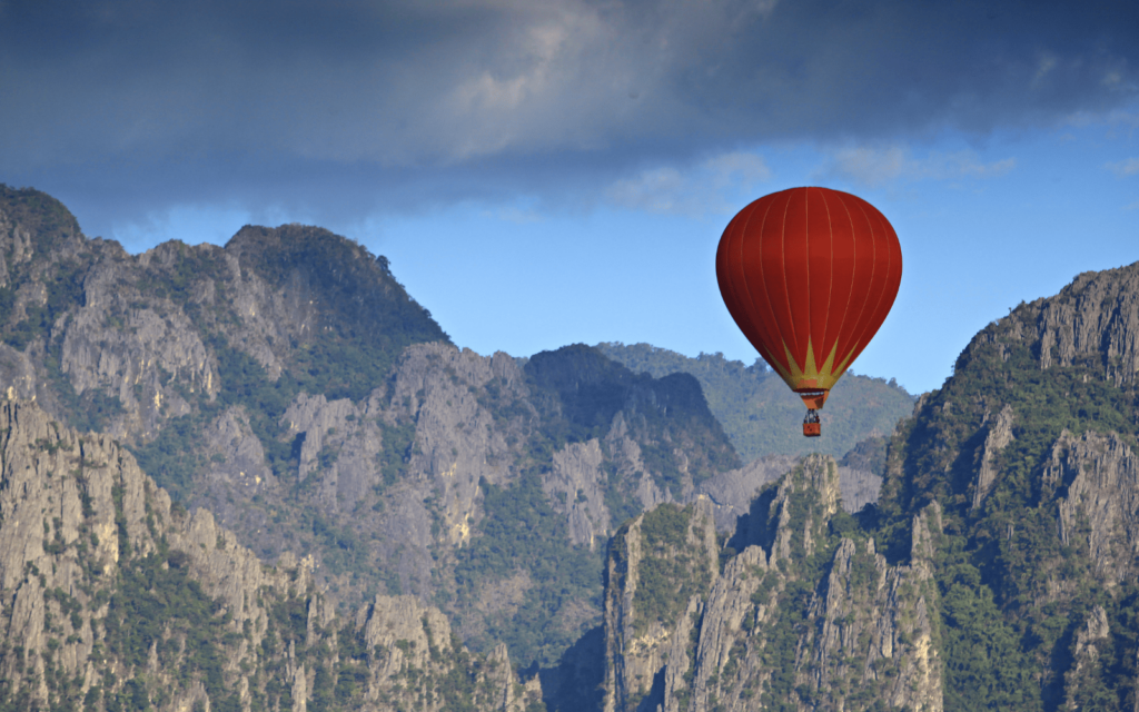 Hot air baloon floating over the limestone karsts of the adventure capital of Laos, Vang Vieng