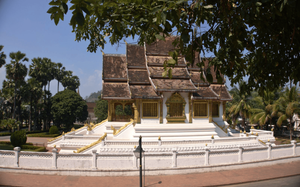 Haw Pha Bang Temple with trees in the background, part of the Royal Palace complex of Luang Prabang and a major attraction for a Laos itinerary-photo-Abby