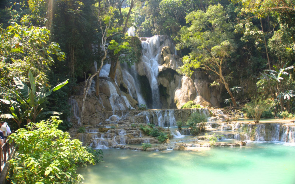 Kuang Si Falls surrounded by lush greenery and a turquise pool at its base, one of the must-see attractions on an Laos itinerary-photo-Abby