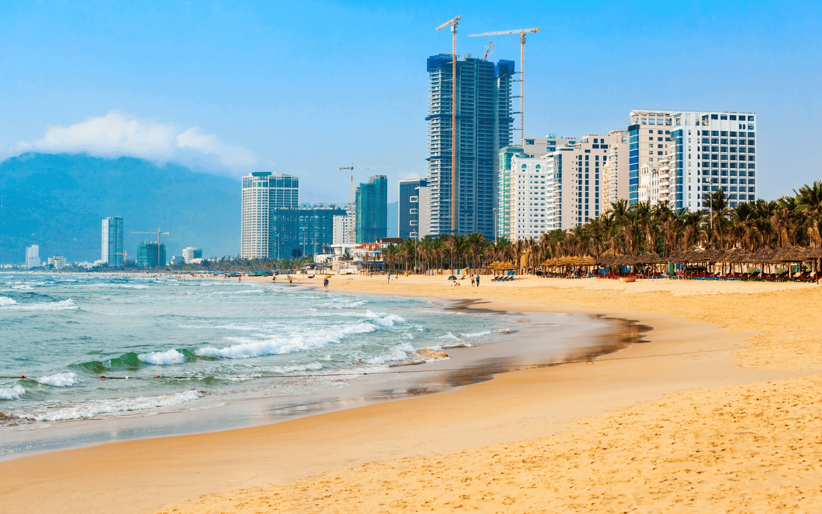 My Khe Beach, on Son Tra Peninsula, one of the most beautiful beaches in Southeast Asia with golden sands, blue water, and buildings in the background