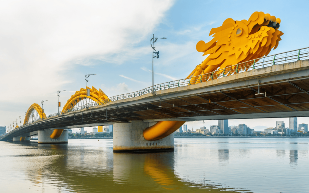 The famous Dragon Bridge of Da Nang Vietnam against a blue sky with white clouds