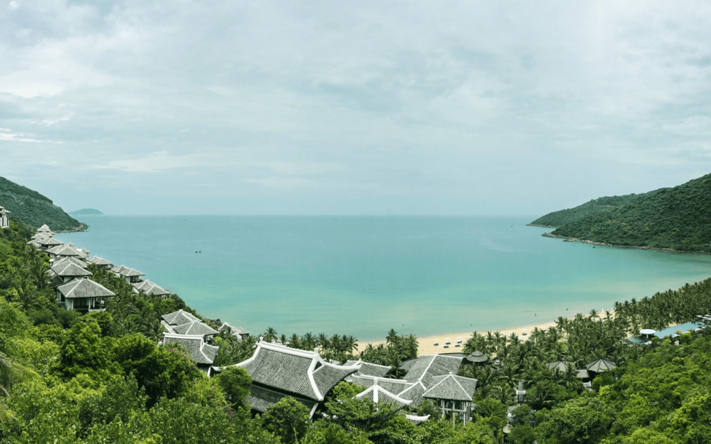 Resort with villas on the beach in Da Nang Vietnam with ocean background and forested hills