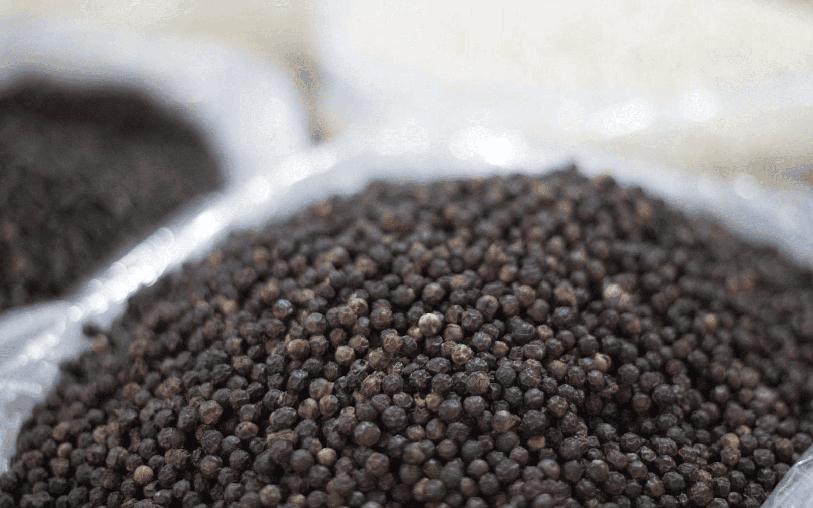 Barrel of black pepper on a blurred background